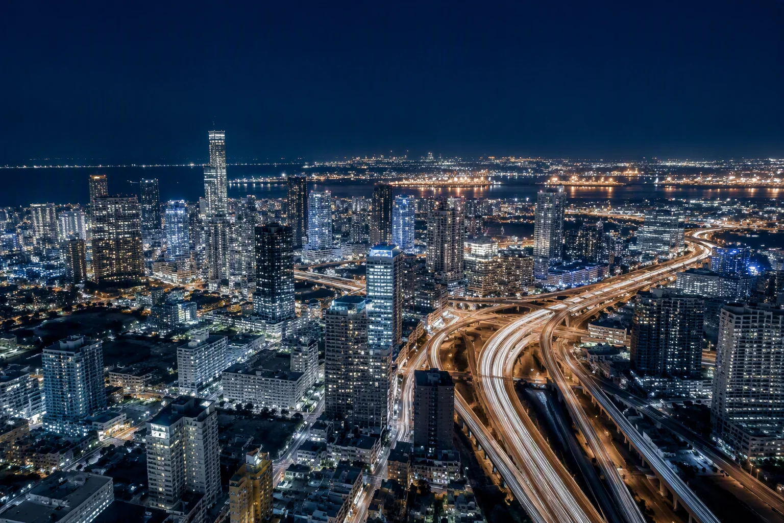 Aerial night view of a modern city with light trails